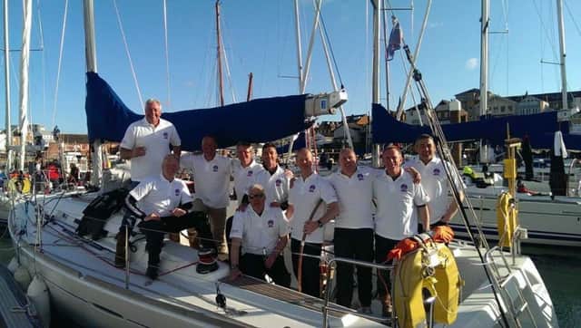 Whitehead firefighter Lenny Entwistle (pictured fifth from right, standing) with his victorious colleagues at UK Firefighters Sailing Challenge.  INLT 18-692-CON