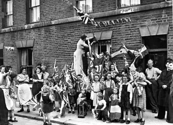 Men, women and children celebrating 'Victory in Europe Day' in the street, as seventy years after the nation broke out in jubilant celebration at the end of the Second World War, Britons will again take to the streets to commemorate VE Day.  PA Wire