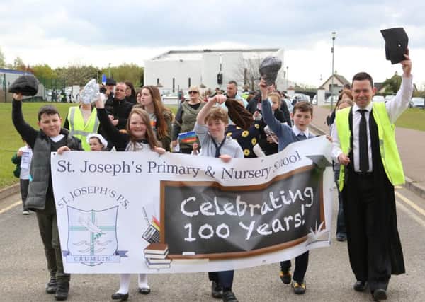 Principal of St Joseph's Primary School with the children taking part in the 100th year celebrations