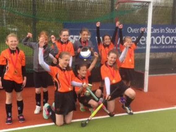 Triumphant Harmony Hill Girls' Hockey team with the Northern Ireland trophy.