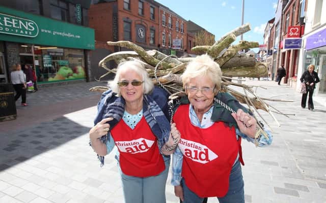 Lisburn grannies Pat Bates and Margaret Moore carrying a bundle of sticks to help raise funds for Christian Aid. US1518-501cd  Picture: Cliff Donaldson