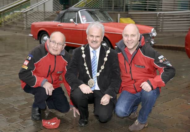 Mayor Thomas Beckett pictured with Italian car enthusiasts Herbie McBratney and Tim Logan ahead of the Northern Ireland Italian Motor Club's All Ireland Italian Motor Show at Lagan Valley Island on Saturday May 30. A range of stylish and desirable Italian cars and motorcycles will be on display at the event.  US1518-521cd  Picture: Cliff Donaldson