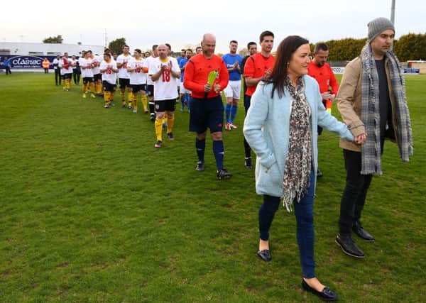 Mark Farren and his wife Terri-Louise lead out Glenavon and Derry City select before his fundraising match at Mournview Park. The former Derry City and Glenavon striker is battling an aggressive brain tumour and is hopeful treatment in Germany could aid that fight. Pic by PressEye Ltd.
