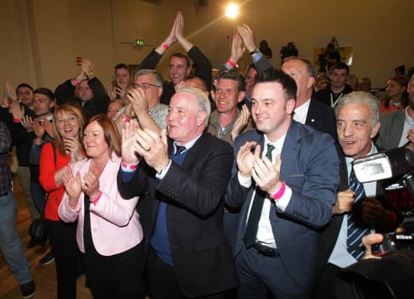 The SDLP supporters celebrate Mark Durkan's victory at Templemore Sports Complex last night. DER1815MC119