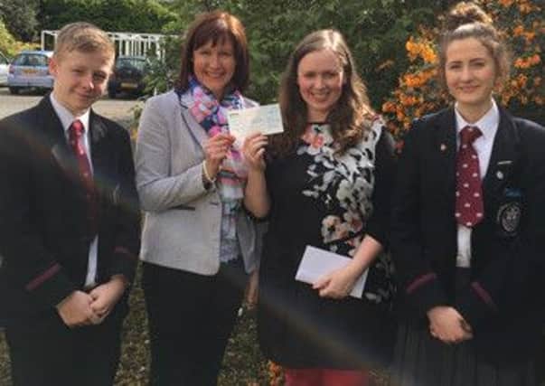 Mrs Ross, Rachel Beasant and Ben Aston present Carol Mulligan with a £630 cheque for the Fields of Life charity. INCT 19-758-CON