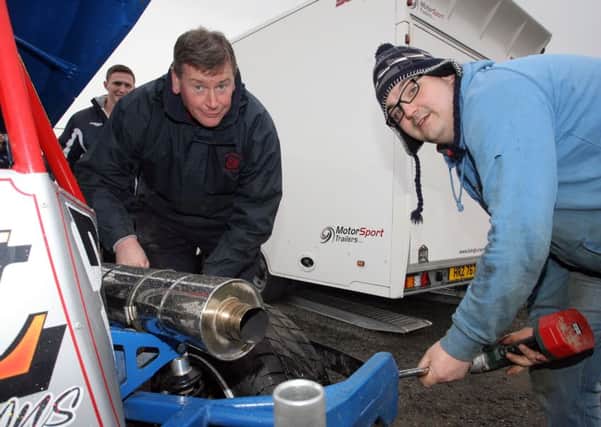 Nigel and Derek makes a few adjustments to their car at Ballymena Raceway. INBT20-229AC