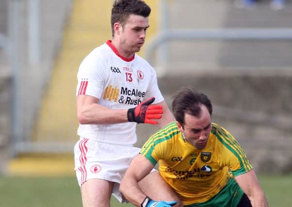 Tyrone's Darren McCurry puts Donegal's Karl Lacey under pressure in the league encounter between the sides. Photo Lorcan Doherty/ Presseye