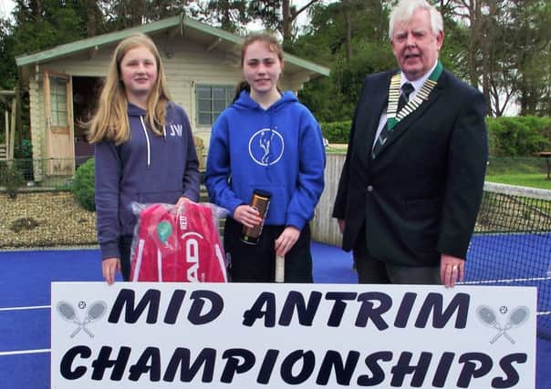 ATT club members Molly Drennan and Sarah McLaughlin who competed in the under-14 girls' novice section of the Mid Antrim Junior Tennis Championships held at the Kells-based club recently. They are pictured with George Stevenson, President of Tennis Ireland.