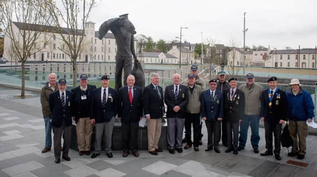 Former US Marines on a tour of Ireland with Military Historical Tours of Woodbridge VA took time to visit Derry on VEDay70 to pay tribute to their predecessors in WWII who guarded the US Naval Operating Base on Foyle. Here they are joined by members of the Londonderry Royal Naval Association and a former US Navy officer at the International Sailor statue on Ebrington Parade Ground. PHOTOCREDIT Stephen Latimer