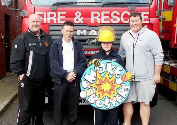 Fintan Loughran with his father Mick Loughran and brother Danny Loughran enjoy a day as a Firefighter with Northern Ireland Fire & Rescue Service Watch Commander Michael Duffy, following his top prize award with the Cancer Focus NI Smokebusters campaign.
