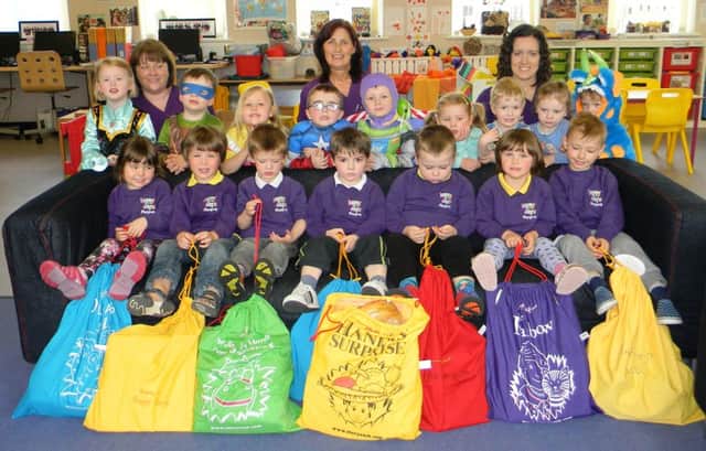 Louise Lenaghan, Jeni Caldwell and Naomi McCaw pictured with some of the children at the launch of the Story Sack initiative in Happy Days Playgroup. INBM20-15 SS