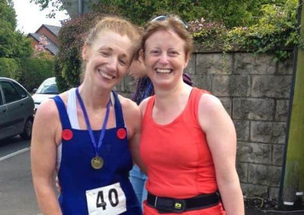 Christine Murray (Super Mario) and County Antrim Harriers colleague Irene Downey at the finish line of Camerons PANDA run. INLT 20-921-CON