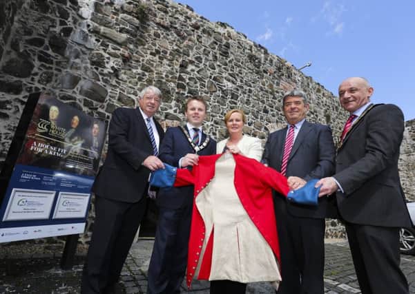 Attending the official handover of The White House to the council are (l-r) Raymond McIlwrath of The White House Preservation Trust; Mayor Thomas Hogg; Chief Executive, Antrim and Newtownabbey Borough Council, Jacqui Dixon; Chairman of The White House Preservation Trust, Cllr Billy Webb; and Deputy Mayor John Blair. They are pictured outside the property holding a Williamite uniform replica jacket from the heritage centre's 'A Tale of Three Kings' exhibition. INNT 20-536CON