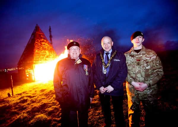 Deputy Mayor John Blair is pictured  at the Carnmoney Hill VE Day beacon lighting ceremony with Ivan Hunter, Whiteabbey Royal British Legion and Corey Gorman, Glengormley Army Cadets. INNT 20-537CON