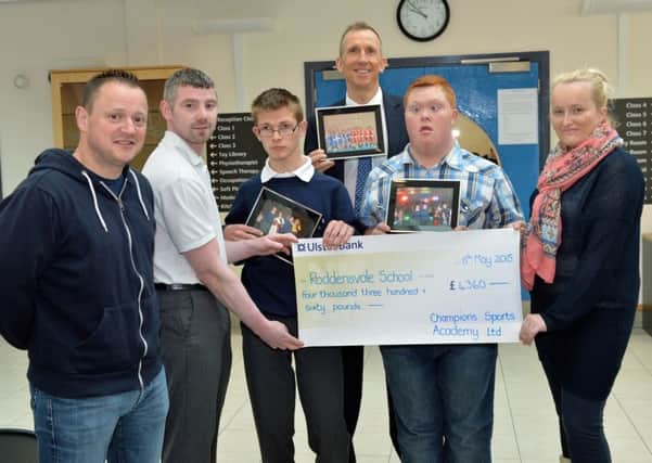Members of the Champions Kick Boxing Club, Larne, John Clarke, Wilson Snoddy and Lynsey Baxter present a cheque for £4360 to Mr John Madden, principal of Roddensvale School and students, Karl and Stephen, the money was raised by members competing in a white collar boxing event. INLT 19-001-PSB