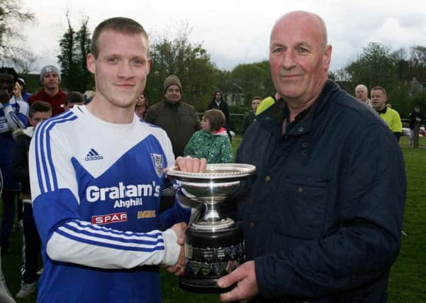 John Stewart, vice-chairman of the BSML, presents the Ace Cup to Ahoghill Thistle captain Jason Stewart, after their 1-0 win over Harryville Homers. INBT21-239AC