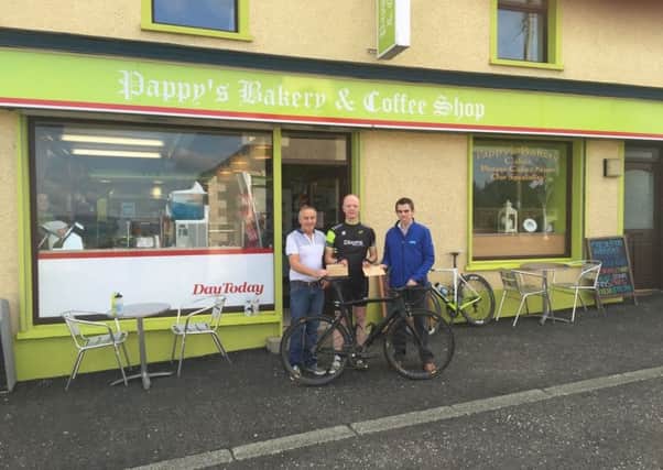 Tommy O'Kane of Pappy's Bakery and Chris McKeown of CDE Global sponsors of the Dunloy GP presenting Dunloy CCs Finbarr Dooey with cheques for prize money