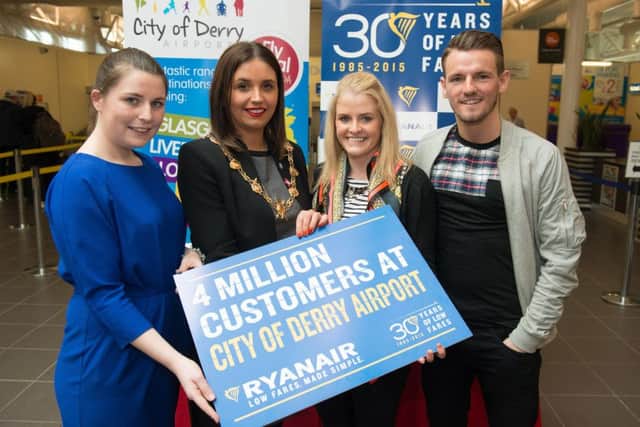 Mayor Elisha McCallion and Lisa Buckley, from Ryanair, who presented Kim Newlands, who is the 4,000,000th passenger to fly with Ryanair from City of Derry Airport, with vouchers for free flights. Included is Kim's partner, David Waters. Picture Martin McKeown. Inpresspics.com. 12.05.15