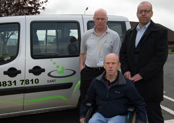 Disabled pensioner Robert Verner who has already had his Dart services reduced due to cutbacks and cannot afford the taxi fares to replace his journeys, pictured along with Dart driver Stephen Sharpe and manager Ian Wilson. INLM2015-401