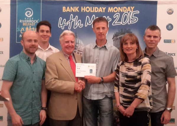 Fit N Running head coach Gregory Walsh and club members receive their awards from the Belfast Marathon.