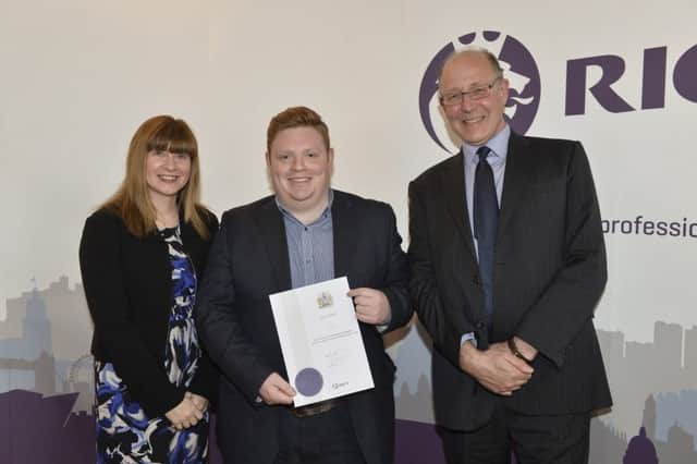 Paul Olding from Carrickfergus, a newly qualified member of RICS (Royal Institution of Chartered Surveyors), receiving his diploma from Fiona Grant, chair RICS UK & Ireland and Paul Kendrick, chair RICS Northern Ireland. INCT 20-799-CON.
