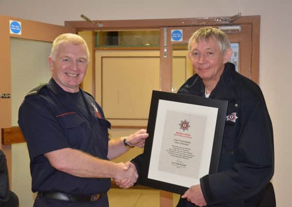 Paul Johnston receives a certificate from Watch Commander Tommy Torbitt for his retirement. INLT-20-719-con