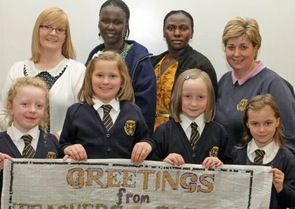 OVER HERE. Teachers from Uganda, Susan Ayo and Violet Sarah Among along with Armoy PS Teachers Marina McKeown and Suzanne Reynolds and pupils, Alice, Tyana, Jane and Kayla.INBM22-15 010SC.