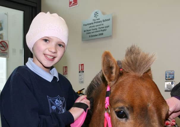Young Molly Taylor grooms Summer the Therapy Pony who visited her school Fourtowns PS last week. INBT21-221AC