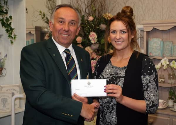 Rachel Moody, of Sally's Florist, is pictured presenting sponsorship for their to Galgorm Castle Golf Club captain Keith Dinsmore. INBT20-226AC