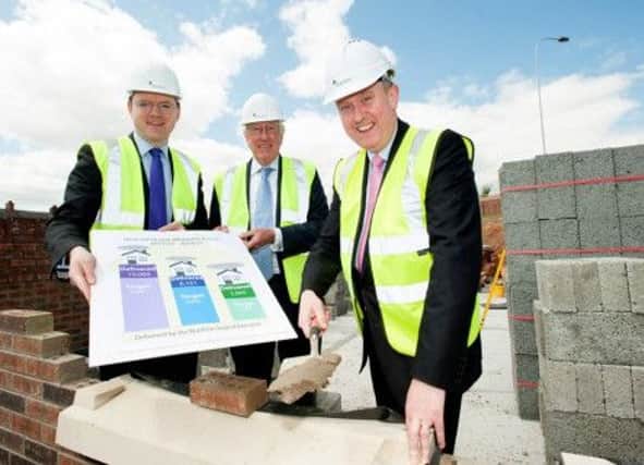 (L-R) Cameron Watt, Chief Executive of NIFHA, with the Chairman of the Housing Executive Donald Hoodless, and Minister Storey, announcing the development figures at an Apex site on North Queen Street, Belfast.