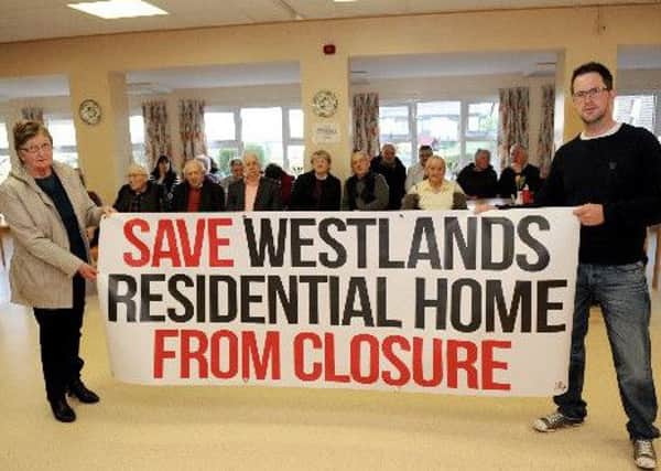 Campaigners hold aloft a banner at the public meeting which was held
at Westlands Residential Home in Cookstown