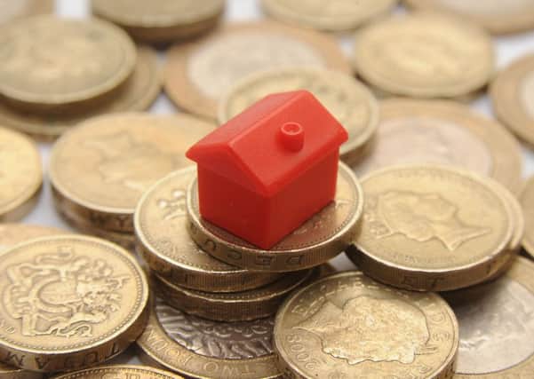 File photo dated 27/01/15 of a plastic model of a house on a pile of one pound coins, as mortgage availability is set to increase further in the coming months as banks and building societies have become more willing to lend to people with deposits below 10%, a Bank of England survey has found. PRESS ASSOCIATION Photo. Issue date: Wednesday April 8, 2015. The Bank's latest Credit Conditions Survey, covering the first quarter of this year, found that demand from home-buyers for mortgages fell in the first three months of the year, continuing a trend seen since the middle of 2014. See PA story ECONOMY Credit. Photo credit should read: Joe Giddens/PA Wire