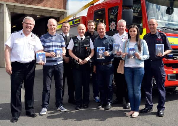 Pictured at the launch of a road safety DVD produced by St Mary's Youth Club, BNL Productions and Craigavon Intercultural Project with the help of the Northern Ireland Fire and Rescue Service and the PSNI are from left, Dale Ashford, assistant chief fire officer, Nick Convey, youth leader in charge, St Mary's Youth Club, Constable Colin Clarke and Sgt Barbara McNally, PSNI, Nick Hutchinson, BNL Productions, Stephen Smith, Craigavon Intercultural Project, Martin Thompson, Portadown Fire Station commander, Jasmine Vale, Craigavon Intercultural Project, and David Lappin, watch commander. INPT20-200.