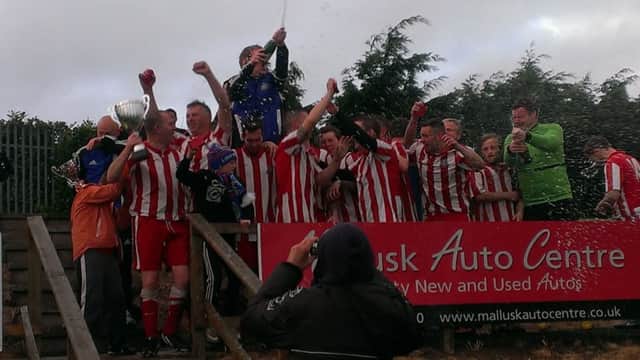 Ballymacash Rangers Thirds lift the Whiteside Memorial Cup after an extra-time 2-1 victory over Moira Albion Seconds.