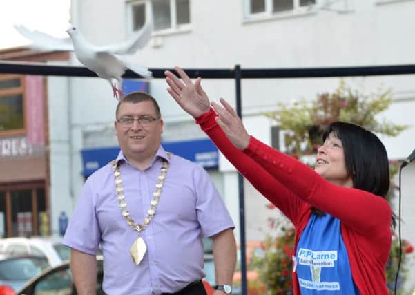 Carlee Letson from PIPS Larne pictured releasing the last white dove to mark World Suicide Prevention Day 2014at Broadway. INLT 39-005-PSB