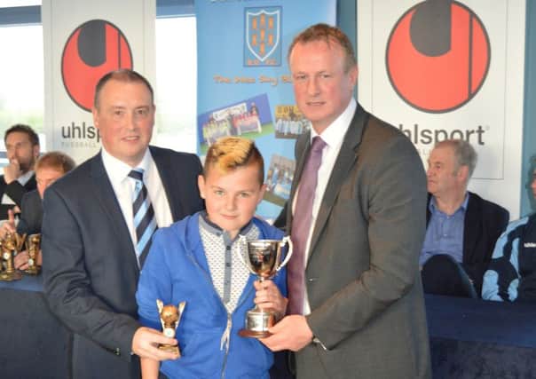 Under-11 Player of the Year Mark Lowry with team manager Davy Douglas and special guest Michael O'Neill.