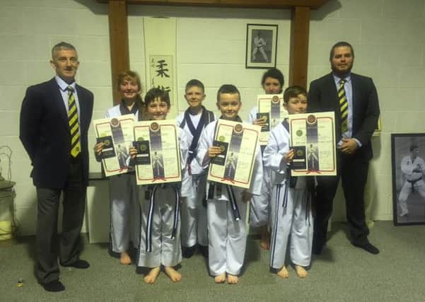 Junior members of The Dojo who attained their black belt qualification at a recent Kobudo Gold Tab Awards ceremony held at the Woodside Road venue. Included are volunteer coach Sensei Ryan Avery and Head coach for the dojo Shihan David Toney.
