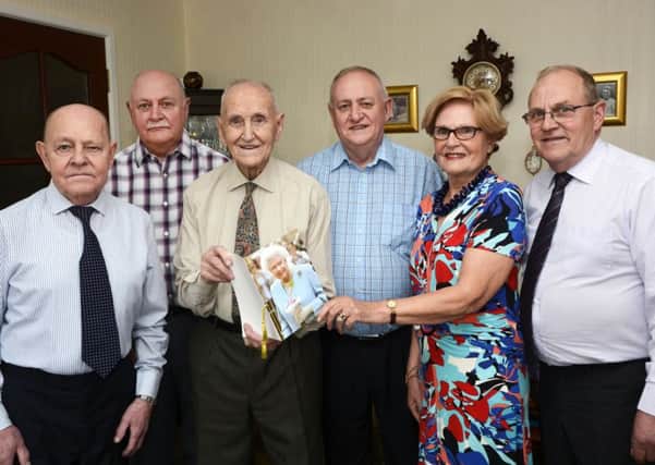 Joe Simpson shows his telegram from the Queen to his children Tom, Walter, Stewart, Daphne and Desmond, at his 100th birthday party. He has 17 grandchildren, 22 great grandchildren and two great great grandchildren. INLS2115-122KM