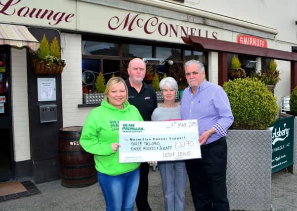 Leslie and Roberta Lewis and John McConnell hand over a cheque to Stefani Mearns from Macmillan Cancer Support for £3,370 which was raised at a charity night at McConnells of Doagh. INNT 19-005-GR