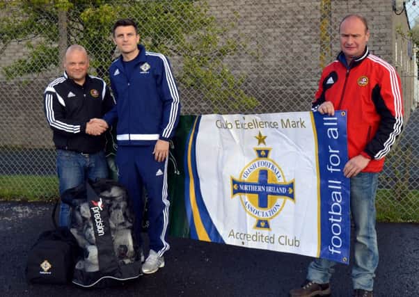 Diarmuid O'Carroll, of the Irish FA, presents Carniny Youth's Stephen Armstrong with the club's IFA Club Excellence Mark Accredited Club Award. Also included is David McComb.