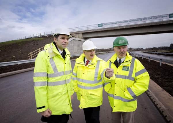 File photo: Pictured with Transport Minister Danny Kennedy during a site visit on the A2 Shore Road are Basil Hassard, Transport NI project manager and Stephen McFaul, project manager. Picture by Brian Morrison
