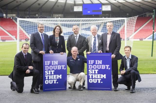 With Peter Robinsn (back, centre) at Hampden Park for the launch of the concussion gudelines are Catherine Calderwood, Chief Medical officer, Scottish Government, Dr Andrew Murray, Royal College of Physicians & Surgeons Glasgow/University of Edinburgh, Dr John MacLean, Scottish Football Association, Dr James Robson, Scottish Rugby Union, Dr Willie Stewart, University of Glasgow, Dr Frank Dunn, Royal College of Physicians & Surgeons Glasgow and Dr Niall Elliott, sportscotland institute of sport. Photo: Jeff Holmes Pix.  INCT 21-751-CON