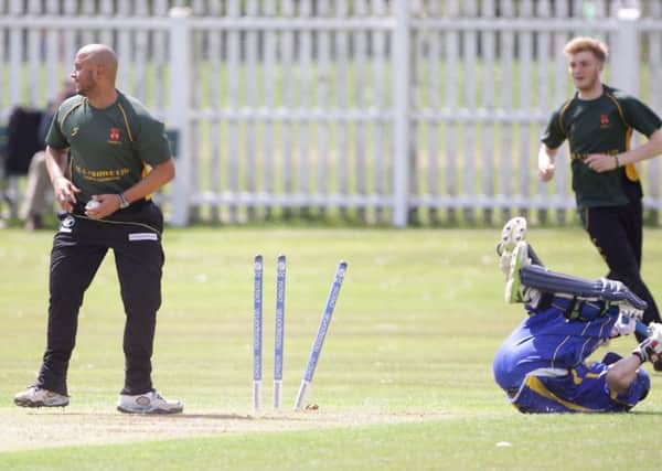 Donemana's Stephen Wallace is run out during Saturday's game against Lisburn, at Wallace Park. US1521-546cd  Picture: Cliff Donaldson