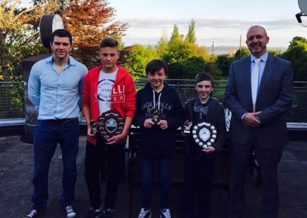 Carrick Grammar U12A Player of the Year Tyrone Simms, Most Improved Player Cameron Long and U12C Player of the Year Adam Welsh with coach Mr Martin and principal Mr Mulvenna. INLT 22-991-CON
