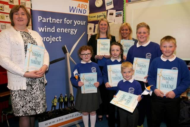 Pauline Davidson, author of the book "Tommy the Turbine" is pictured presenting copies of her book to pupils from Carnalbanagh PS. Included is Ald. Maureen Morrow and Tamzin Frazer (ABI NI Limited). INBT22-206AC