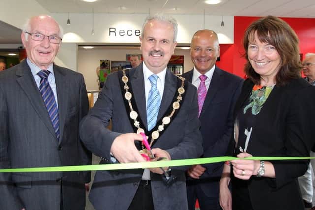 Mayor Thomas Beckett, along with, from left, Larmour Stewart, chair of the trustees, Clive Irwin, club chairman, and Cynthia Smith, Deputy Secretary at DCAL, cuts a ribbon to open the new reception area at Lisburn Racquets Club. US1521-564cd Picture: Cliff Donaldson