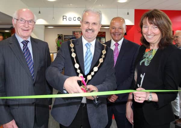 Mayor Thomas Beckett, along with, from left, Larmour Stewart, chair of the trustees, Clive Irwin, club chairman, and Cynthia Smith, Deputy Secretary at DCAL, cuts a ribbon to open the new reception area at Lisburn Racquets Club. US1521-564cd  Picture: Cliff Donaldson