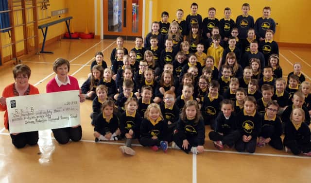 PUPILS CHEQUE. Pictured with a cheque for £183.66 which was presented by pupils at William Pinkerton PS on Monday are Maureen Elliott and Valerie Hamilton (Sec) from Ballymoney RNIB Branch.INBM14-15 038SC.