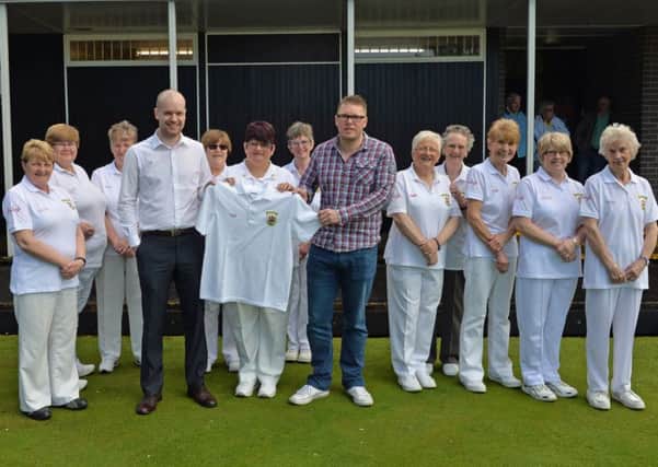 William Noble and Gareth Liken from Ruby's Bar present Sonia McDermott, president of Curran Ladies' Bowling Club, with new shirts for the 2015 season. INLT 22-017-PSB Photo: Phillip Byrne