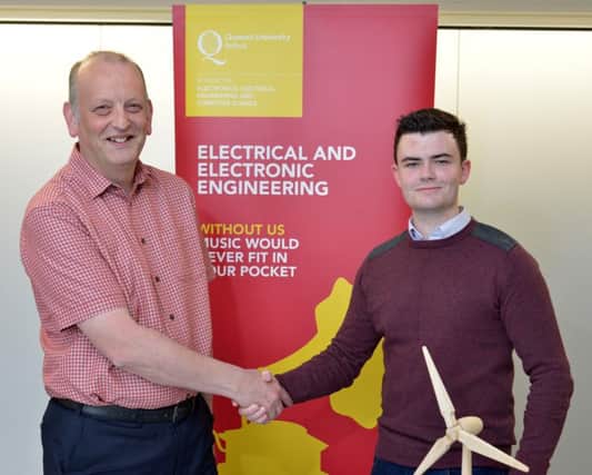 James is pictured being congratulated by Dr David McNeill, Assistant Director of Education for Electrical and Electronic Engineering at Queens. INBM20-15